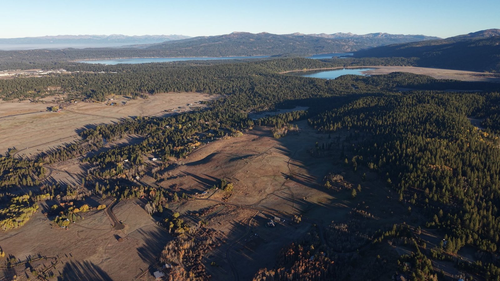 Aerial view over Shaw Ranch with Payette Lake and Little Payette Lake on the horizon